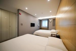 a hotel room with two beds and a tv at Hotel Dada Gyeongbokgung in Seoul +91 photos