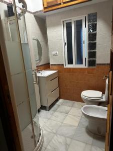 a bathroom with a toilet and a sink at Casa Cervantes in Granada