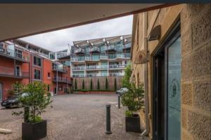 an empty parking lot with a building in the background at Boxwood IXL Luxe Hobart Waterfront Apartment in Hobart