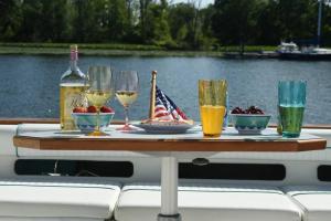 a table on a boat with wine glasses and a flag at Beautiful Yacht on Catskill Creek in Catskill