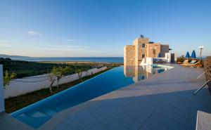 a view of the infinity pool of a villa at Iliada by Vintage Travel in Maleme