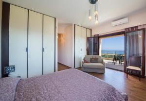 a bedroom with a bed and a view of the ocean at Iliada by Vintage Travel in Maleme +30 photos