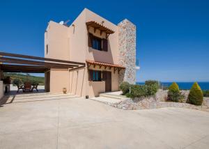 a house with a view of the ocean at Iliada by Vintage Travel in Maleme