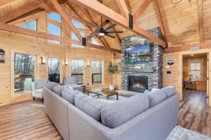 a living room with a couch and a fireplace at Stunning Sevierville Cabin: Hot Tub w/ View in Sevierville