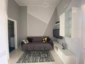a living room with a couch and a tv at Horizon in Castel San Giorgio