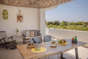 a table with a plate of fruit on it in a living room at Ai Helis Summer House by Vintage Travel in Svoronata