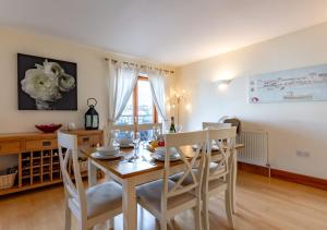 a kitchen and dining room with a table and chairs at 14 Neptune House in Milford Haven