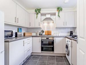 a kitchen with white cabinets and a dishwasher at 3 Bed in Overstrand 81481 in Overstrand
