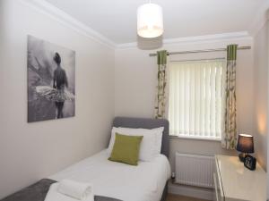 a small bedroom with a bed and a window at 3 Bed in Overstrand 81481 in Overstrand
