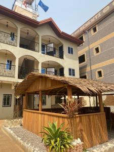a hotel with a large building with a thatch roof at RÉSIDENCE MARTHA in Yaoundé