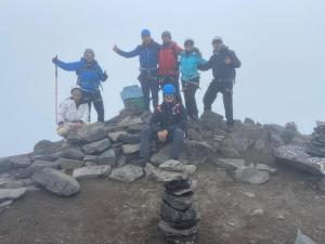 a group of people standing on top of a mountain at Ilinizas Wasi Hospedaje in Machachi +1 photo