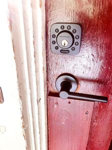 a close up of a red door with a handle at Large Lodge at Rainier Lodge (0.4 miles from entrance) in Ashford