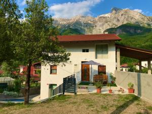 a house with a mountain in the background at Apartma Pep in Kobarid