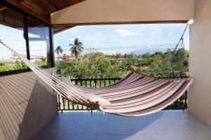 a hammock on the balcony of a house at Blu House Nature & Tours in Chachagua