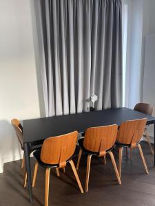 a black table with four chairs around it with a window at Laurel Point in London