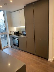 a kitchen with a refrigerator and a stove at Laurel Point in London