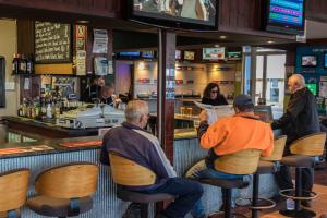 people sitting at a bar in a restaurant at Moruya Waterfront Hotel Motel in Moruya
