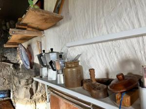 a kitchen counter with various items on a shelf at Appartement charmant à Valleraugue avec terrasse, 40 m² in Valleraugue +5 photos