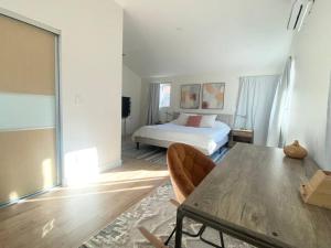 a bedroom with a bed and a table with chairs at Modern Two Bedroom Two Bath W/ Parking and Laundry in Los Angeles