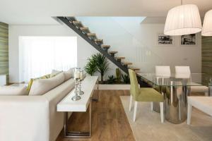 a living room with a white couch and a glass table at Cosy Chalet in Várzea with Private Pool in Várzea