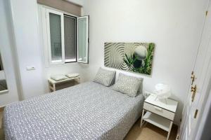 a white bedroom with a bed and a window at 2 bedrooms appartement with wifi at Arcos de la Frontera in Arcos de la Frontera