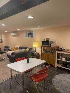 a living room with a table and a couch at Sweet Beech St Retreat in Portland