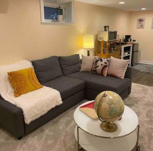 a living room with a couch and a table at Sweet Beech St Retreat in Portland