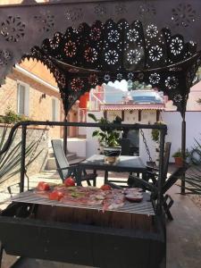 an outdoor grill with a table with food on it at One bedroom appartement with wifi at San Cristobal de La Laguna 3 km away from the beach in Las Lagunas