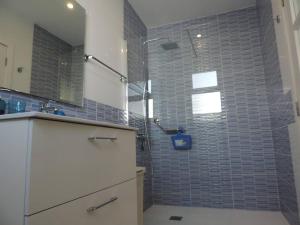 a bathroom with a shower with blue tiles on the wall at One bedroom appartement with wifi at San Cristobal de La Laguna 3 km away from the beach in Las Lagunas