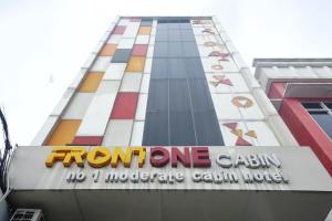 a tall building with a sign that reads front one casino at Front One Cabin Setiabudi Solo in Solo