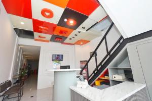 an office lobby with an orange and white ceiling at Front One Cabin Setiabudi Solo in Solo