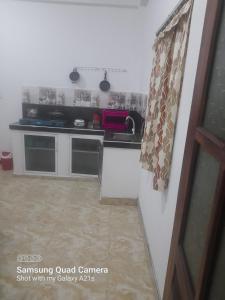 a small kitchen with a sink and a counter at Eura Villa in Bentota