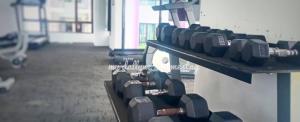a row of dumbbells on a wall in a gym at My Dallyne's Homestay at The Heights Residence, Ayer Keroh, Melaka in Ayer Keroh