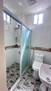 La salle de bains est pourvue d'une douche, de toilettes et d'un lavabo. dans l'établissement Clubmiller Guesthouse, à Puerto Princesa