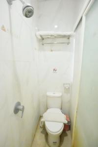 a small bathroom with a toilet in a stall at Front One Cabin Setiabudi Solo in Solo
