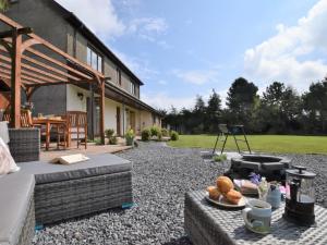 a backyard with a grill and a table with a plate of bread at 3 Bed in Brecon 83076 in Aber-Brân