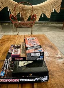 a stack of books on a table with a chair at Cabinas El Jardín in Río Claro +4 photos
