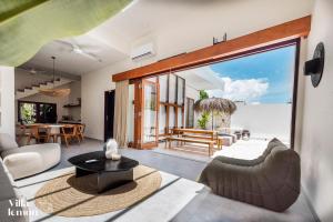 a living room with a couch and a table at Beach Villas Canggu 300m from Echo Beach in Canggu