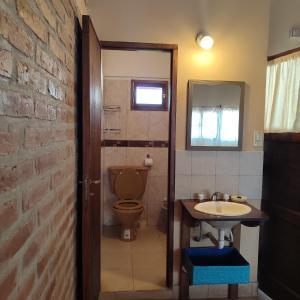 a bathroom with a toilet and a sink at Luna de Cuarzo in Cafayate