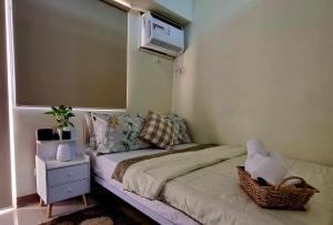 a bedroom with a bed with a air conditioner on the wall at Field Residence SMDC 1BR w/ Netflix in Manila +28 photos
