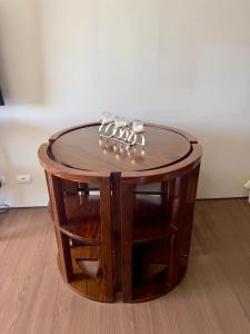 a circular wooden table with a glass top on a wooden floor at Condo near Ateneo and Royal Mandaya in Davao City