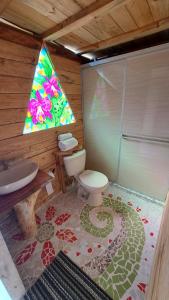 a bathroom with a toilet and a sink and a window at Los Nevados Ecolodge in Gigante