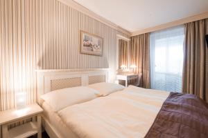 Ένα ή περισσότερα κρεβάτια σε δωμάτιο στο Hotel Maxant