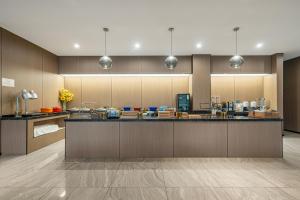a large kitchen with a large counter top at Orange Hotel Shanghai Hongqiao Airport Caoan Road Branch - Free Hongqiao Airport & Hongqiao Train station Shuttle Bus in Shanghai