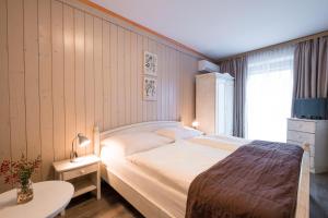 Ένα ή περισσότερα κρεβάτια σε δωμάτιο στο Hotel Maxant