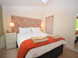 a bedroom with a bed with two towels on it at 1 Bed in Abergavenny 47886 in Abergavenny
