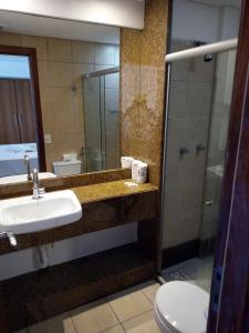 a bathroom with a sink and a shower at Mirador Vista Mar 110 in Natal