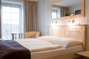 Ένα ή περισσότερα κρεβάτια σε δωμάτιο στο Hotel Maxant