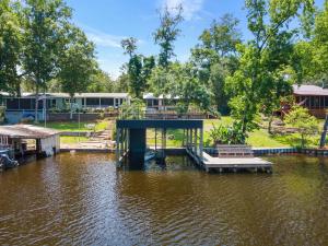 a dock in the middle of a body of water at Waterfront on Lake Talquin - Near FSU - Stunning Views - 2 Story Deck - Fire Pit - Fast 1000 mbps Internet - 3 min from Boat Ramp in Tallahassee