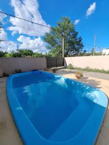a large blue swimming pool in a backyard at Hostal El soleado in Navarro